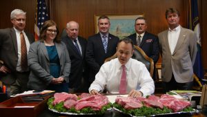 Today, Gov. Matt Bevin and Ag Commissioner Ryan Quarles proclaimed May as Beef Month in Kentucky. Pictured, from left, Kentucky Cattleman’s Association executive vice president Dave Maples, Kentucky Beef Council director of Consumer Affairs Kiah Twisselman, Governor’s Office of Agriculture Policy executive director Warren Beeler, Kentucky Commissioner of Agriculture Ryan Quarles, Beef Council president David Lemaster, and Beef Council chairman Steve Dunning. Pictured in center, Gov. Matt Bevin.